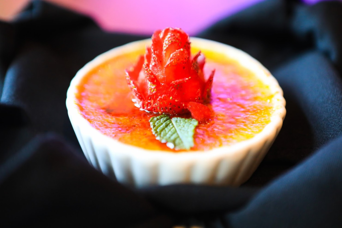 Creme brulee with a strawberry decoration